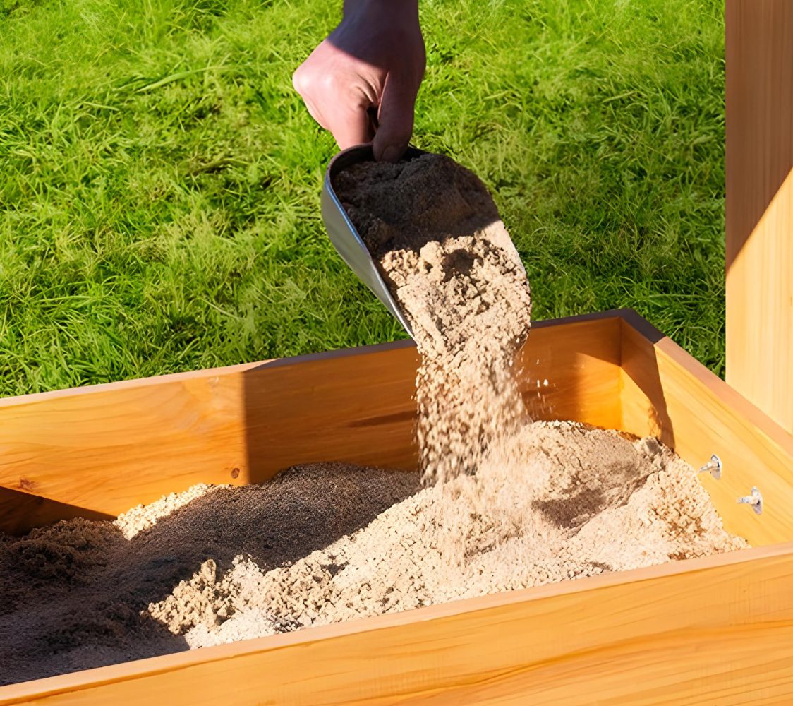 caja para arena en el gallinero	